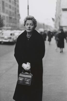 Woman with white gloves and a pocket book