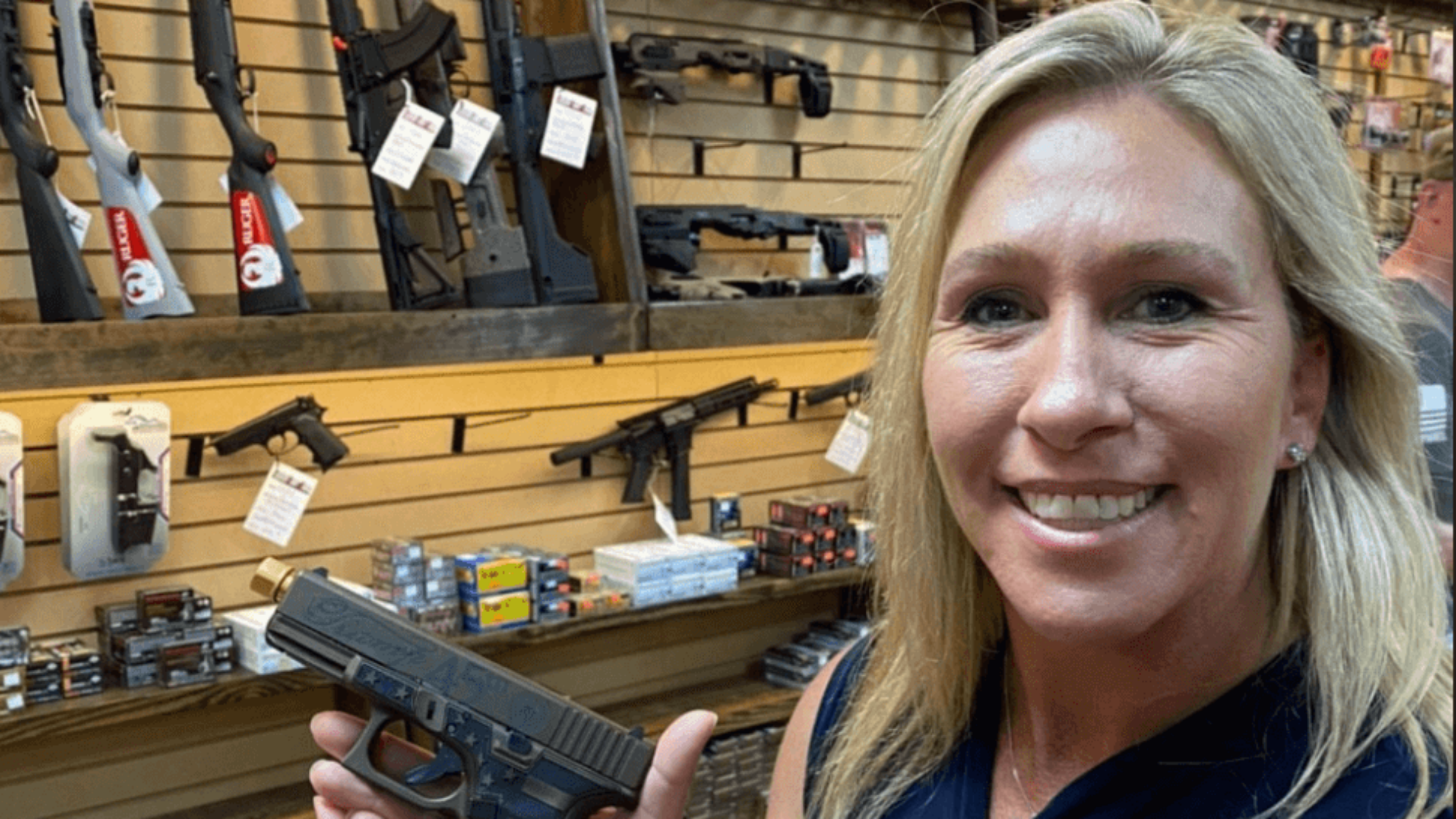 U.S. Rep. Marjorie Taylor Greene, Republican of Georgia, holds a gun. 