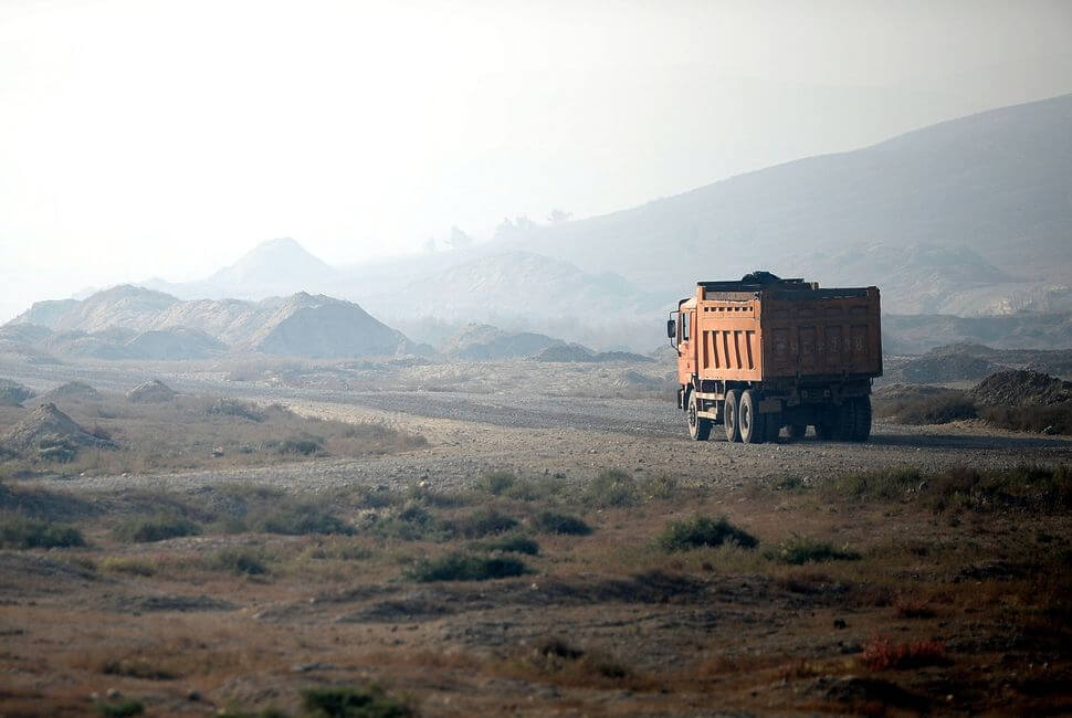 This picture taken on September 18, 2014 shows a truck carries ores from a quarry in the outskirts of Urumqi, farwest China’s Xinjiang region, where millions of Uyghur live.