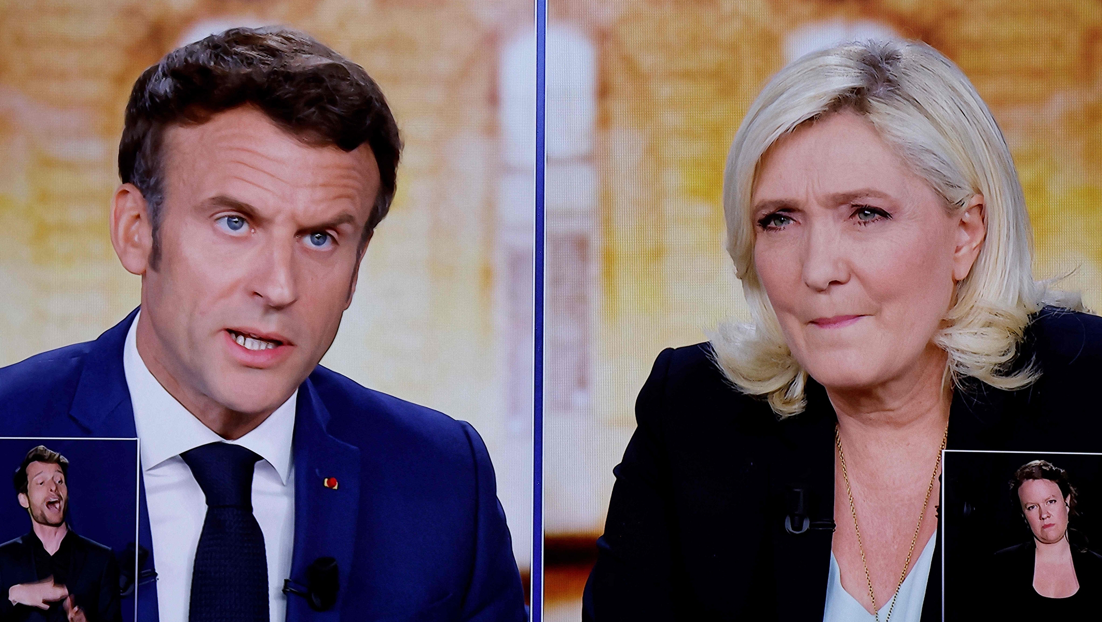 French President Emmanuel Macron and his challenger Marine Le Pen shown during a debate in Saint-Denis, France, April 20, 2022. (Ludovic Marin/AFP via Getty Images)