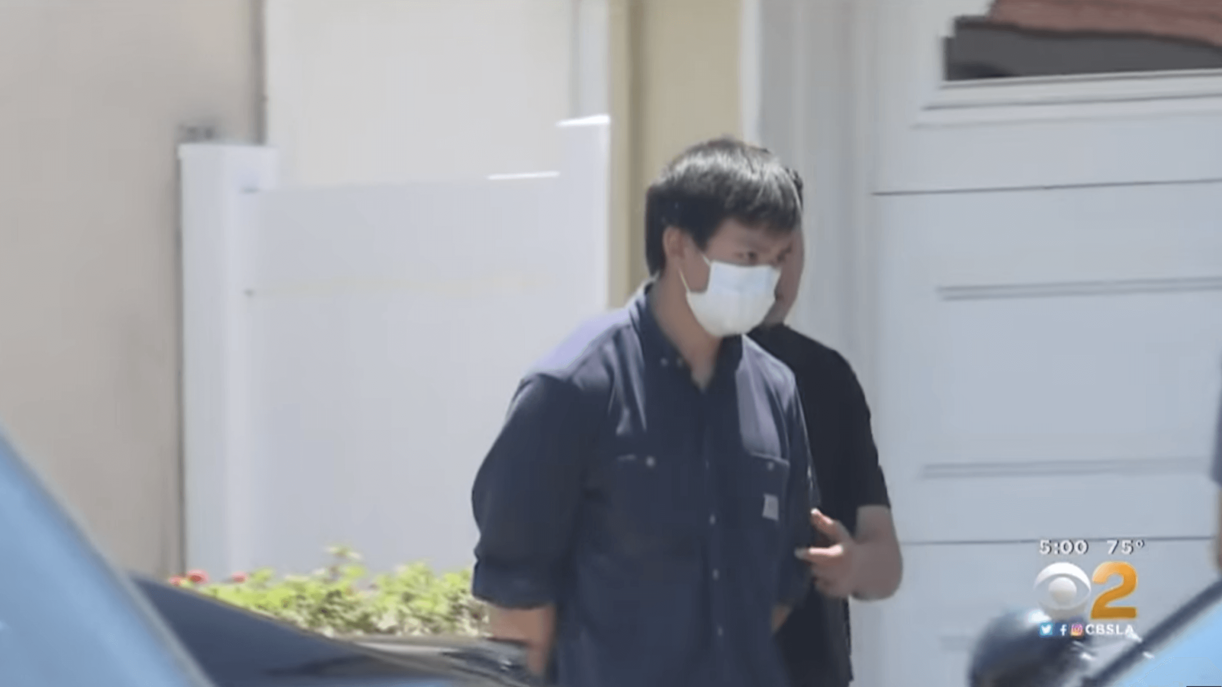 Jason Fong is led to a patrol car by authorities after his arrest in May 2020.