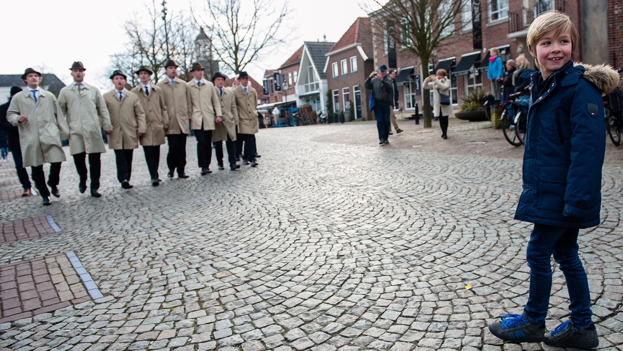 A boy approaches the singers of the traditional Easter caroling procession of Ootmarsum, the Netherlands, April 1, 2018. (Romy Arroyo Fernandez/NurPhoto via Getty Images)