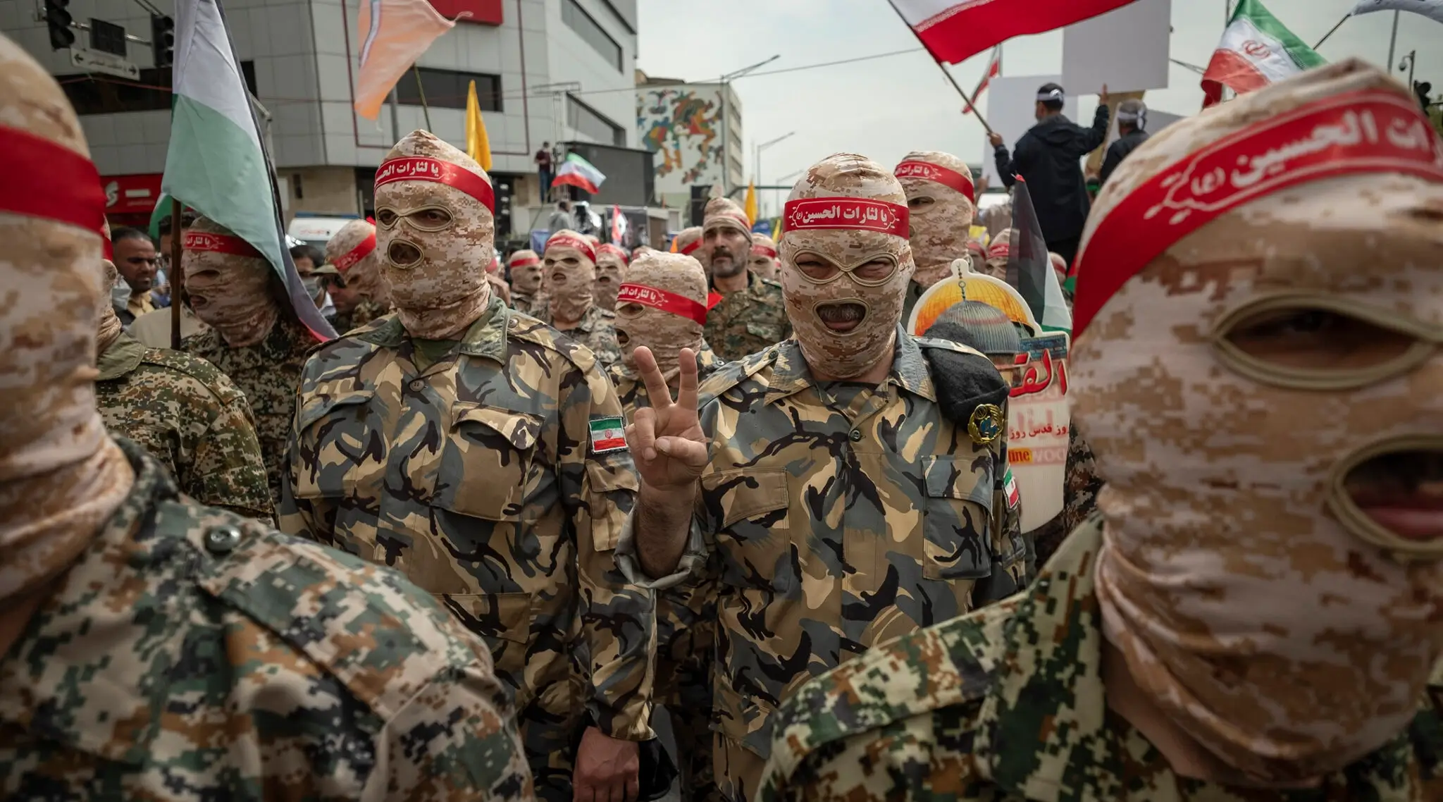 An Islamic Revolutionary Guard Corps (IRGC) member flashes a victory sign during a rally commemorating the International Quds Day, also known as the Jerusalem day, in downtown Tehran, April 29, 2022. 