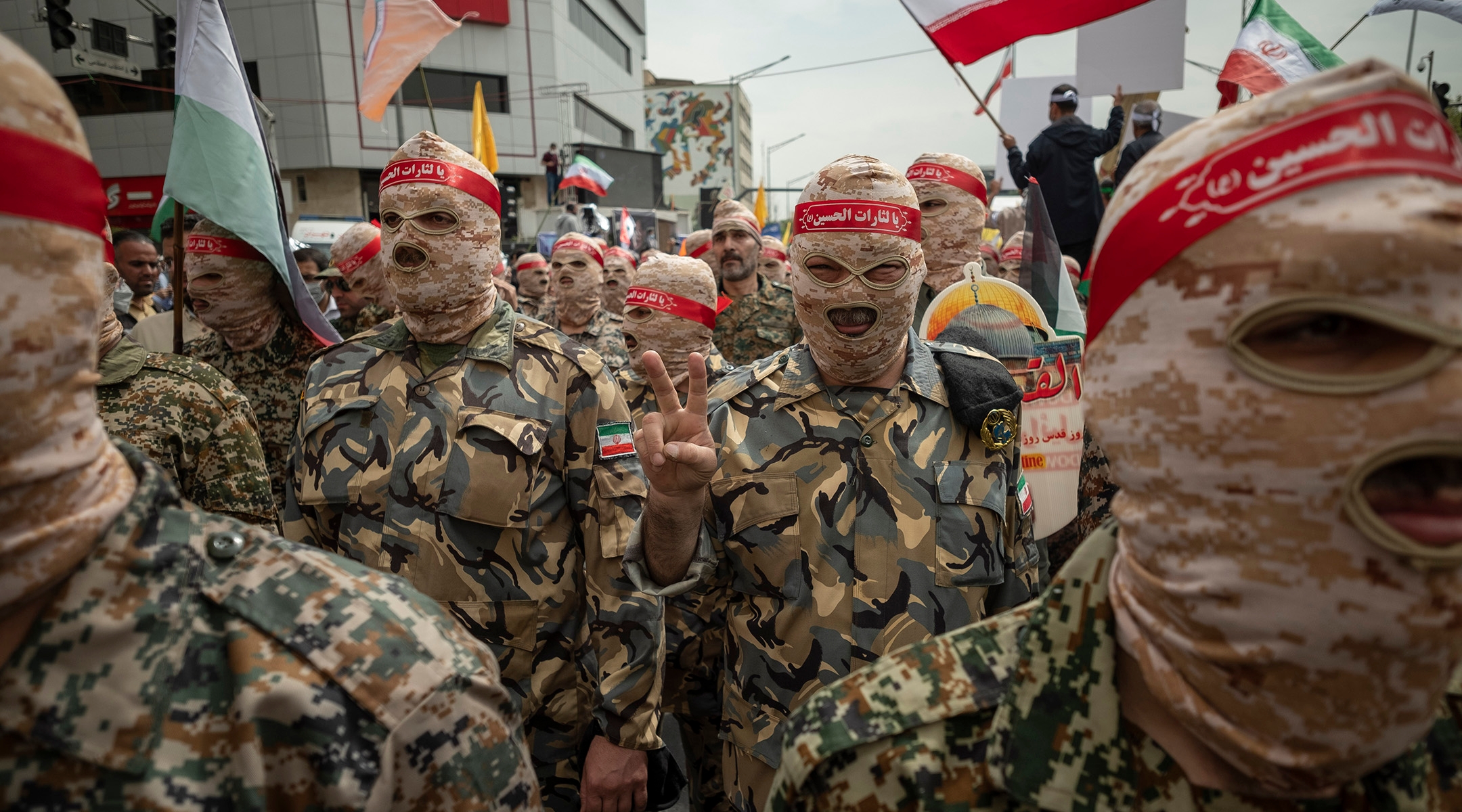 An Islamic Revolutionary Guard Corps (IRGC) member flashes a victory sign during a rally commemorating the International Quds Day, also known as the Jerusalem day, in downtown Tehran, April 29, 2022. (Morteza Nikoubazl/NurPhoto via Getty Images)