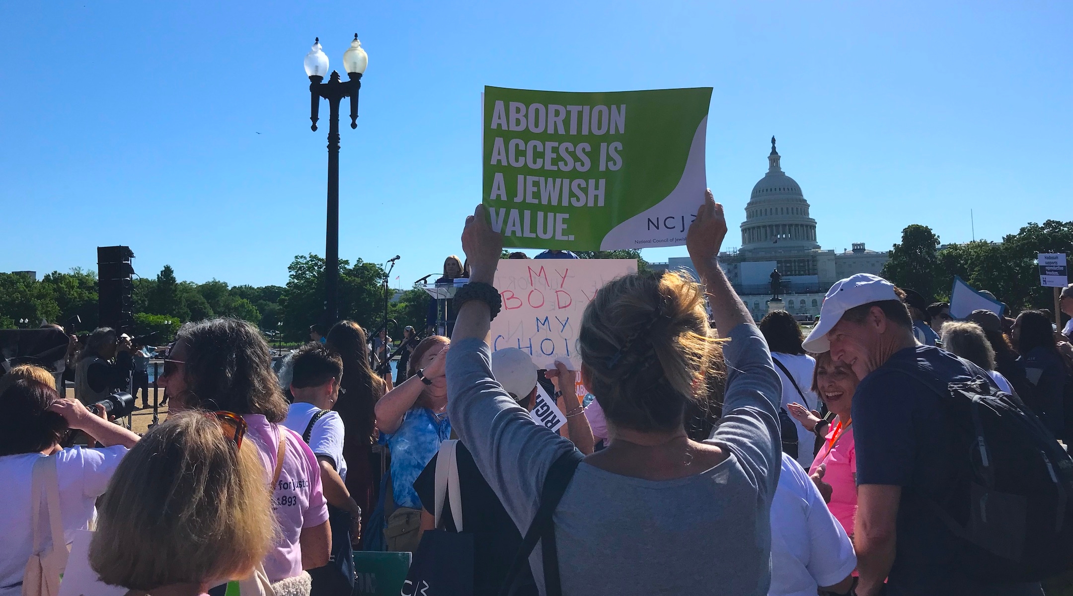 A protester holds up a sign reading “Abortion Access is a Jewish Value” at a rally in front of the US Capitol Building organized by the National Council for Jewish Women, May 17, 2022. (Julia Gergely)