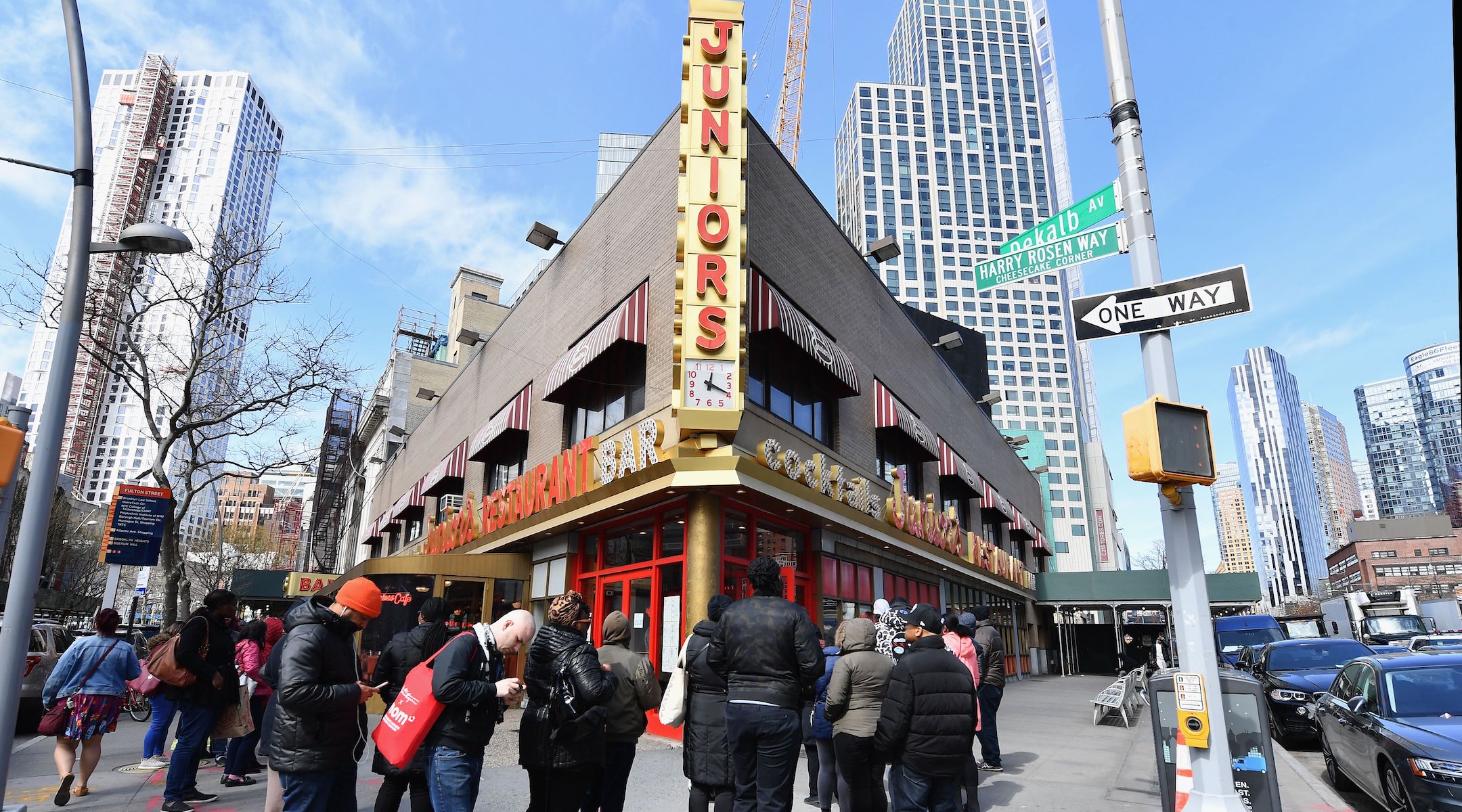 People stand in line outside Junior’s restaurant to pick up food to go on March 16, 2020 in the Brooklyn Borough of New York City. (Photo by ANGELA WEISS/AFP via Getty Images)