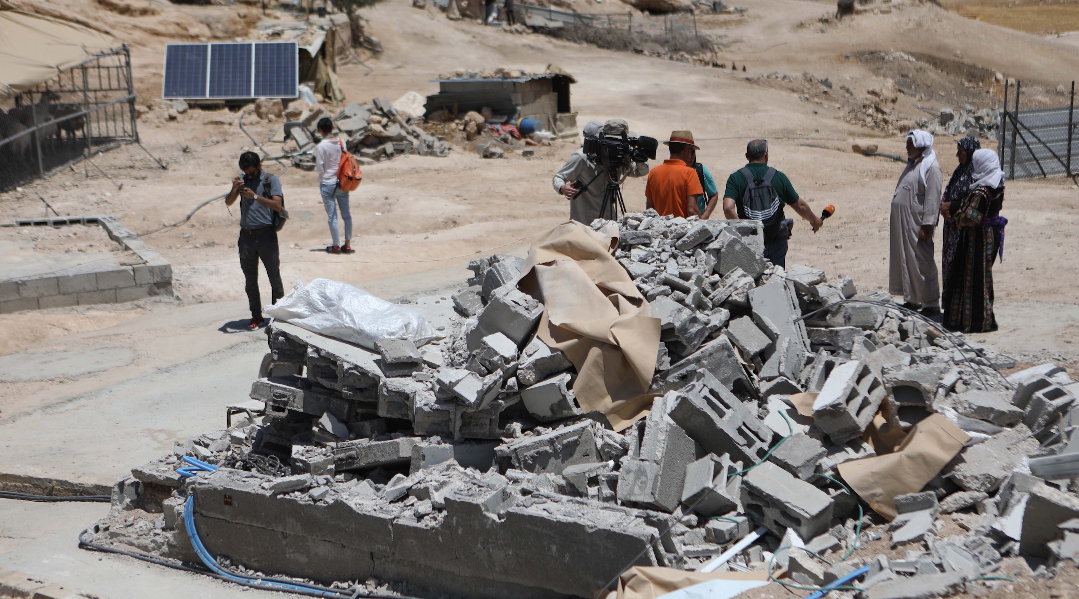 Members of Palestinian Masafer Yatta communities in the West Bank regard the remains of their West Bank homes, May 7, 2022. (Mamoun Wazwaz/Anadolu Agency via Getty Images)