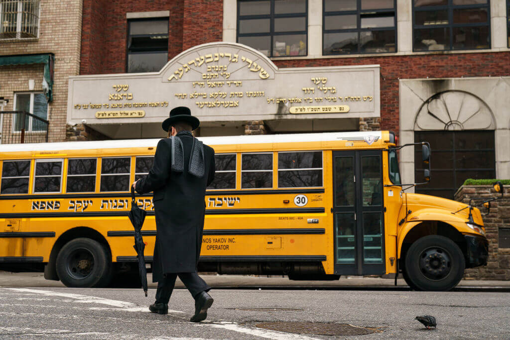 A man walks past Yeshiva Kehilath Yakov School in the South Williamsburg neighborhood of Brooklyn, April 9, 2019