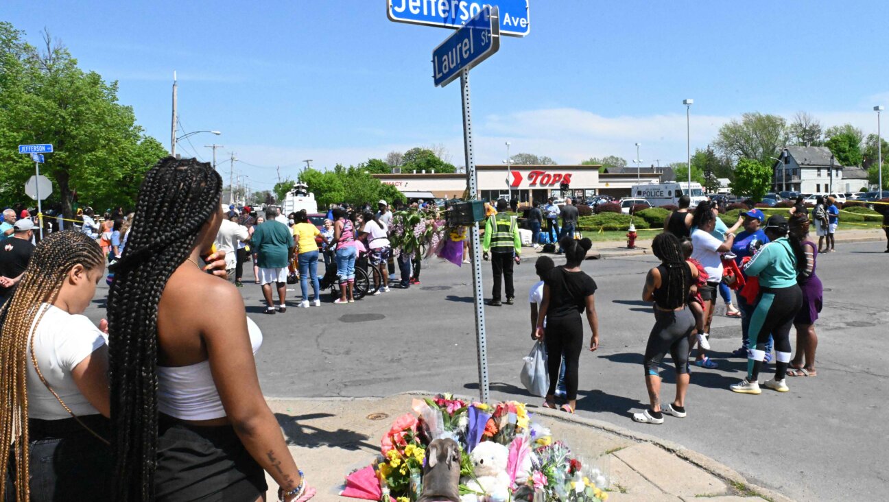 Community members participate in an August vigil near Buffalo's Tops Grocery store, the site of the mass shooting carried out by a white supremacist who targeted African-Americans, despite a manifesto that focused on his hatred of Jews.