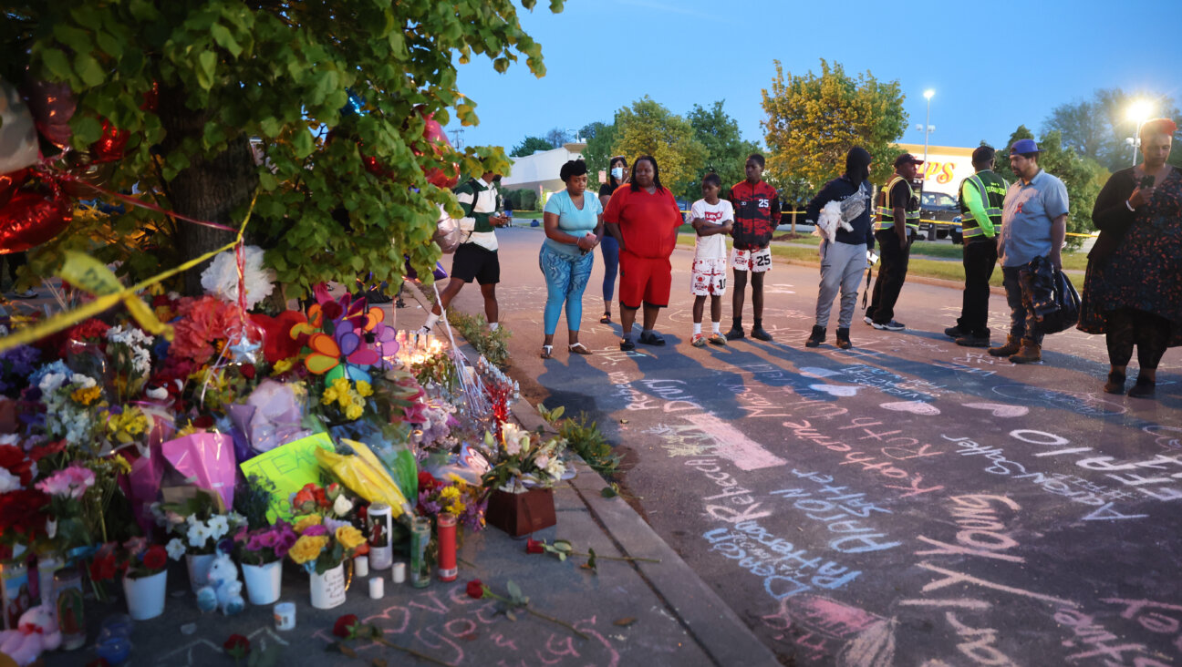 Names of victims and messages of healing are chalked on the ground at a makeshift memorial outside of Tops market on in Buffalo, New York.