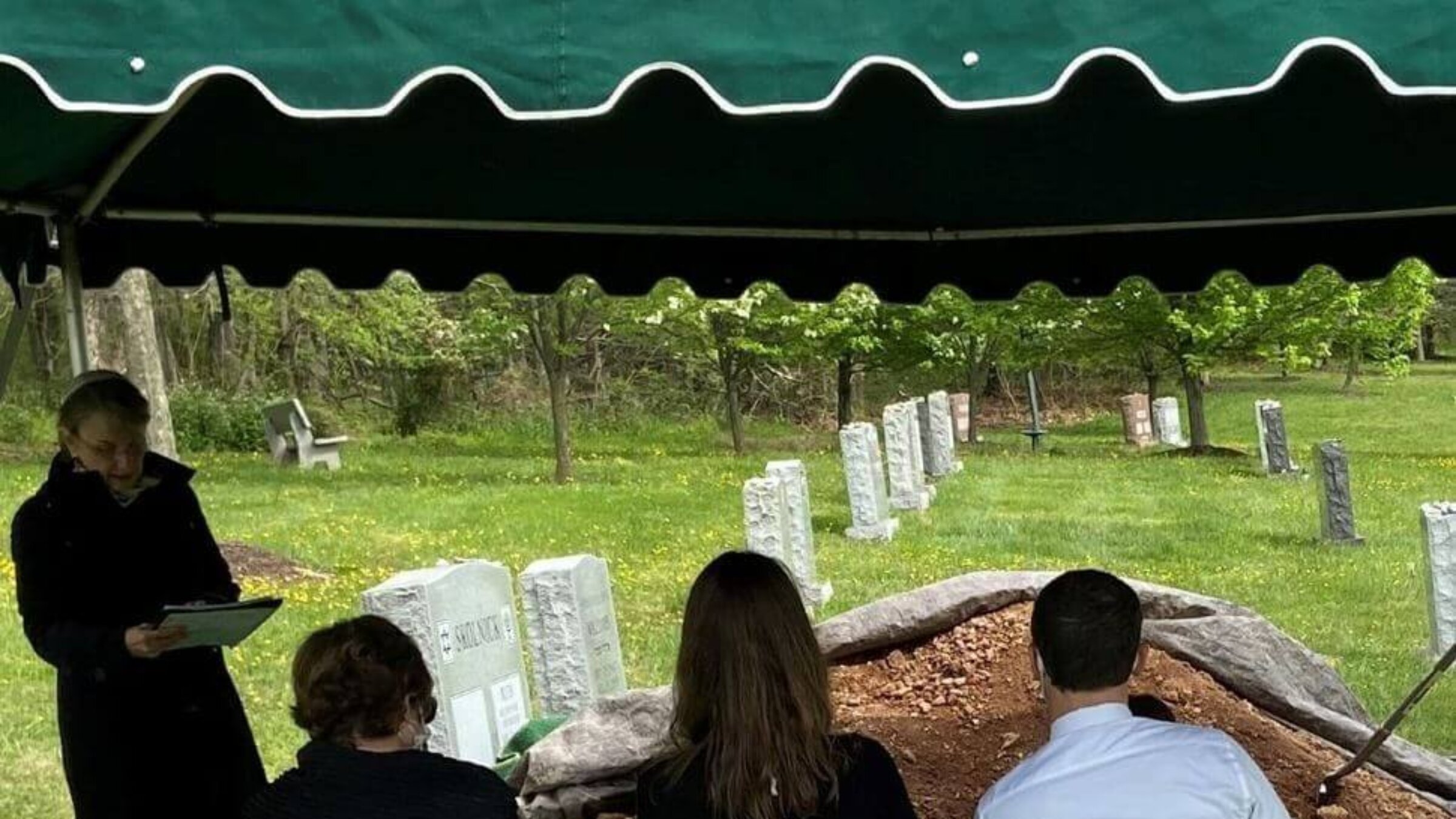 A rabbi and three mourners at a pandemic-era funeral at Garden of Remembrance Memorial Park in Clarksburg, Md.