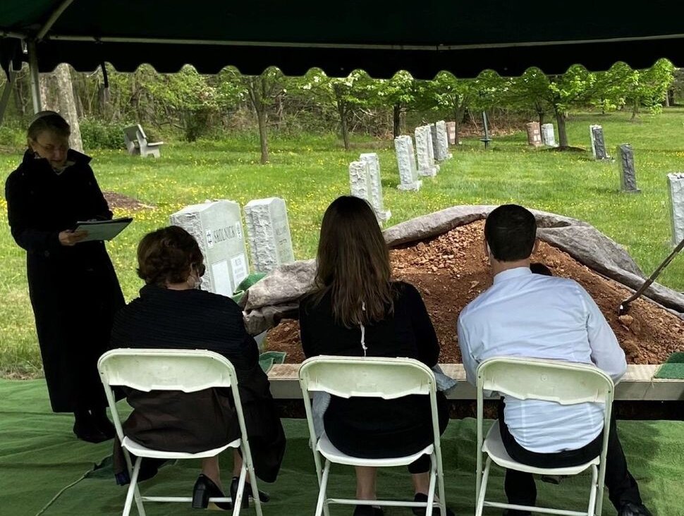 A rabbi and three mourners at a pandemic-era funeral at Garden of Remembrance Memorial Park in Clarksburg, Md.