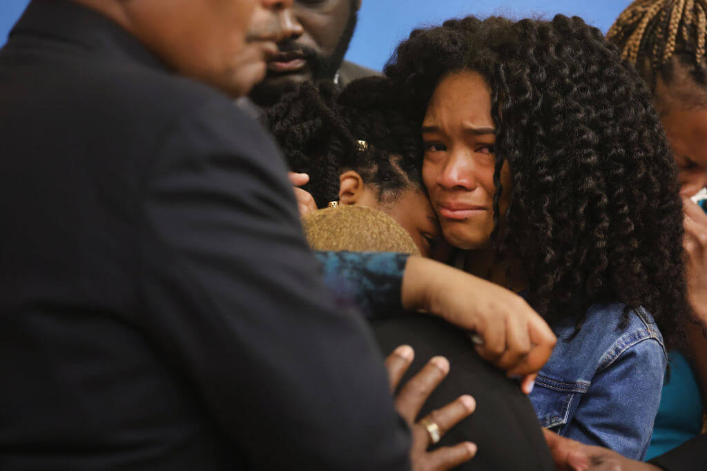 Family members of 86-year-old Ruth Whitfield, who was killed during a mass shooting at Tops market, listen as attorney Benjamin Crump speaks during a press conference on May 16, 2022, in Buffalo, New York.