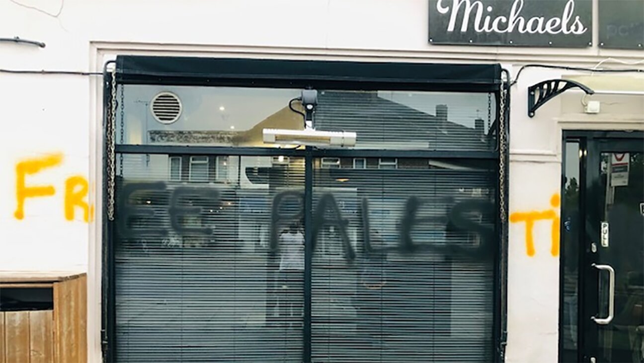 The words “free Palestine” were spray-painted on the facade of a cafe owned by an Israeli in London, May 14, 2022. (Michael Levi)