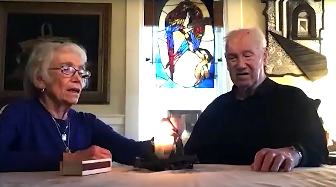 Fred Manasse, a child Holocaust survivor, and his wife Annette light a candle last month at Boston’s Yom Hashoah virtual gathering in memory of Herbert Karliner, one of the last survivors of the ill-fated SS St. Louis ship of Jewish refugees from Nazi Germany. (Courtesy of theJewish Community Relations Council of Greater Boston)