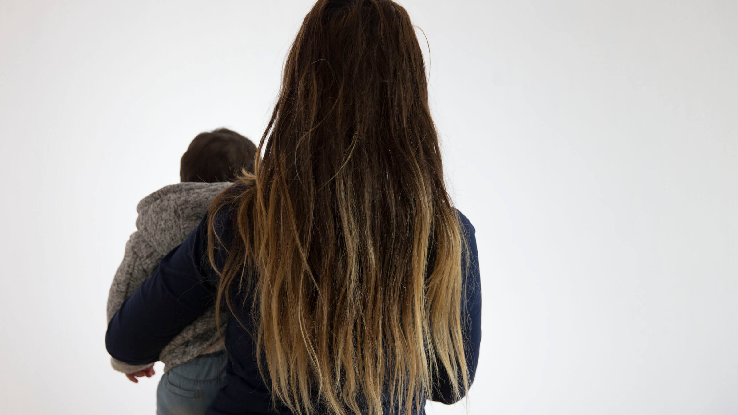 A mother and her child in a temporary relocation shelter for victims of domestic violence