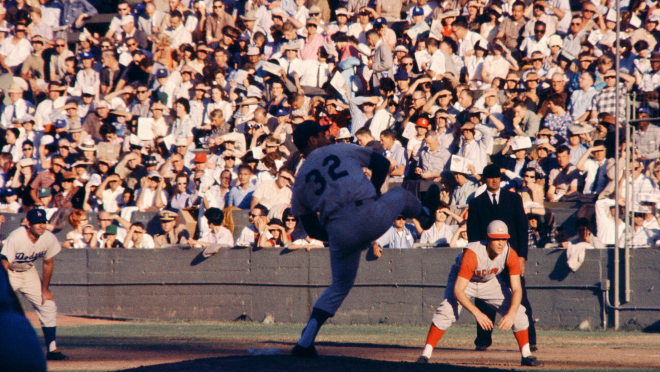 Sandy Koufax pitches during a 1961 game at the Los Angeles Memorial Coliseum. (Hy Peskin/Getty Images)