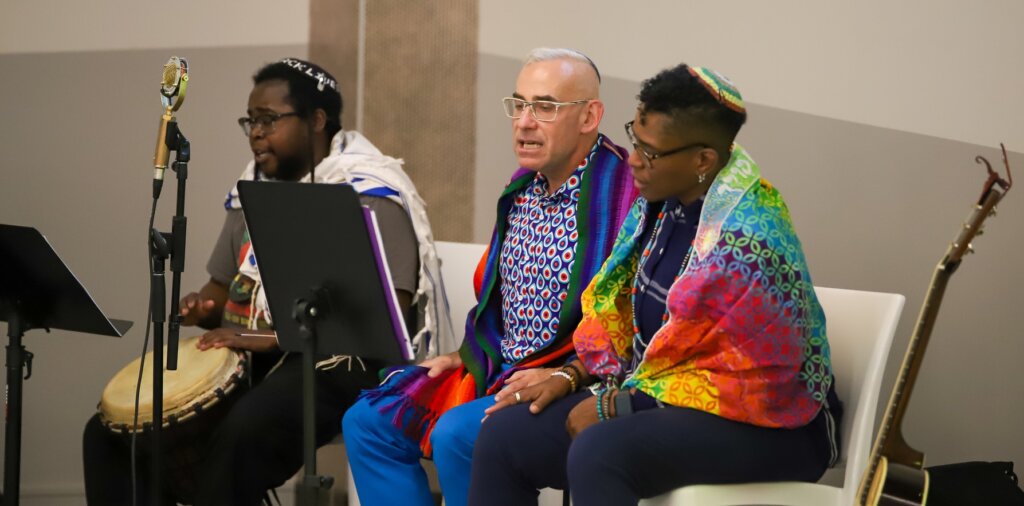 Dr. Koach Baruch Frazier, a rabbinical student at the Reconstructionist Rabbinical College; Rabbi Joshua Lesser, rabbi emeritus of Congregation Bet Haverim; and Rabbi Sandra Lawson, founder of Koh HaPanim and director of diversity, equity, and inclusion at Reconstructing Judaism lead the Juneteenth Kabbalat Shabbat celebration in Atlanta. 