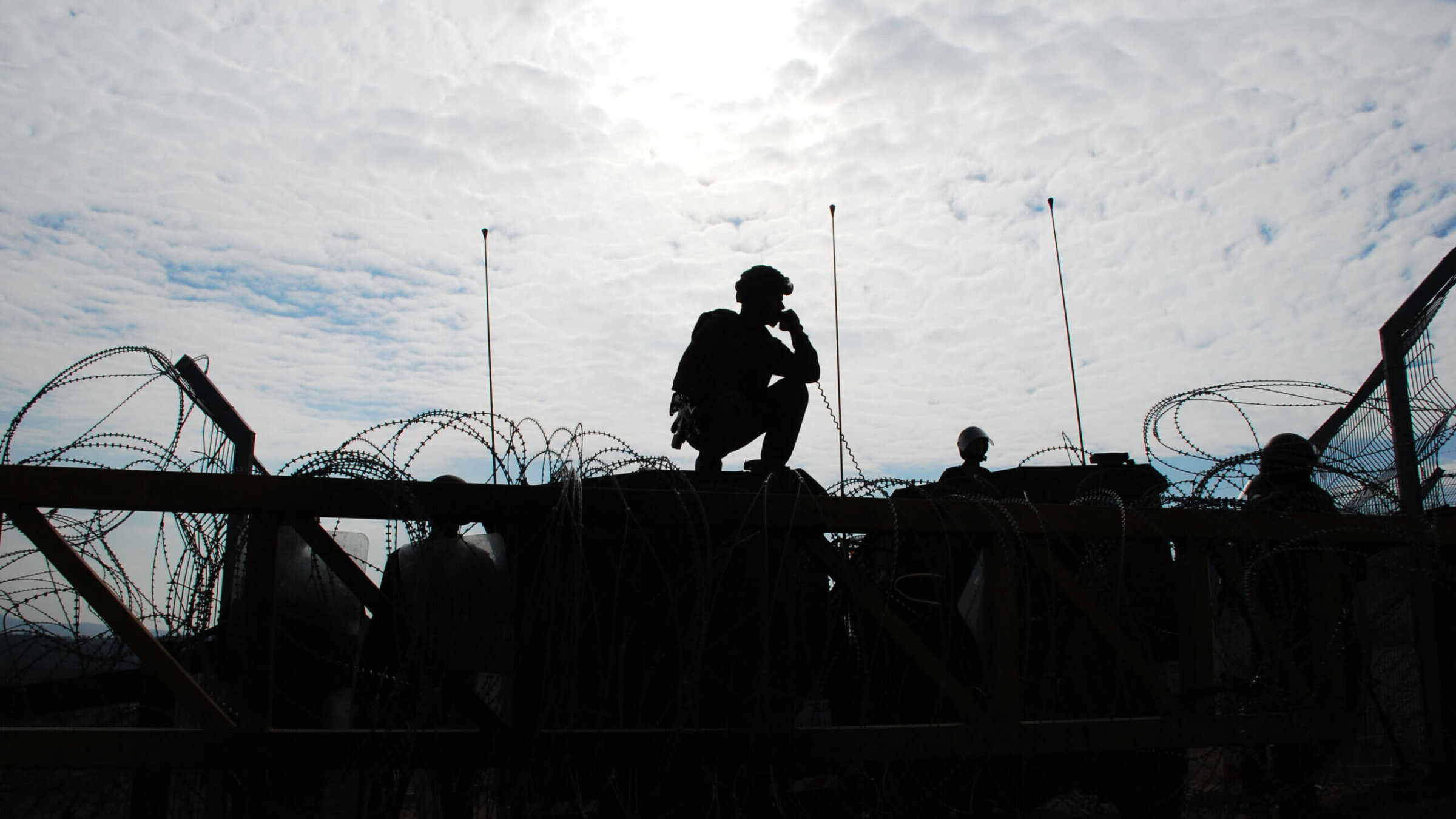 Israeli soldiers guarding a barrier.