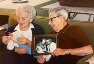 Gray-haired couple hold baby