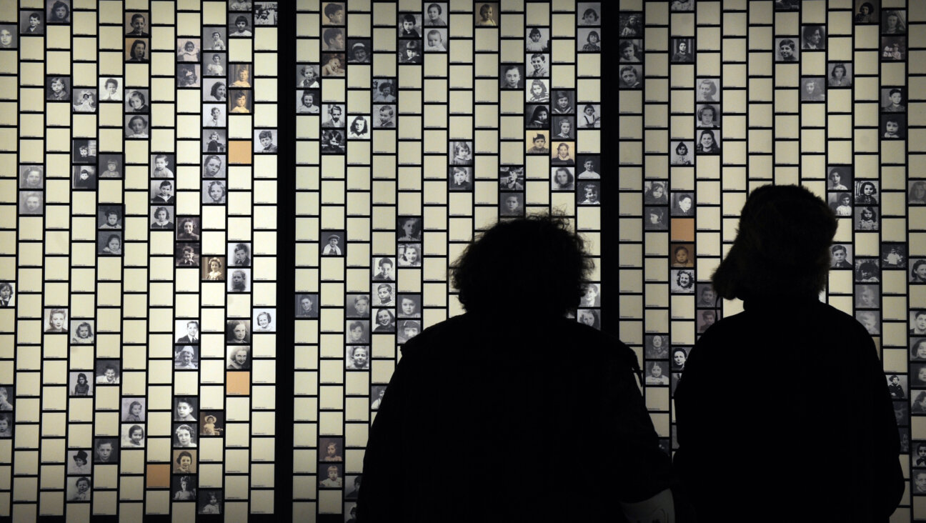 Following the unveiling of a memorial dedicated to the children of the Paris Vel D'Hiv round-up, people look at photographs of the victims.