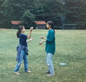 Two girls juggling in wide field