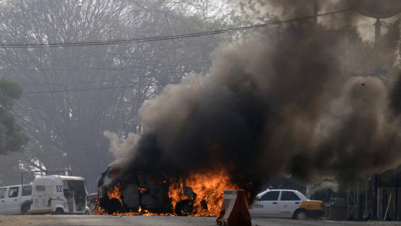 Smoke rises from a burning car in the state of Guerrero, Mexico, in 2019. The torching of cars and other violence took place last weekend in Baja California. 