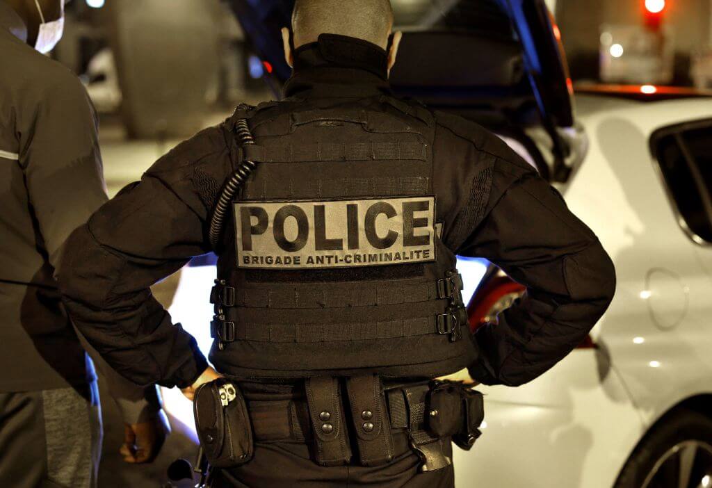 A French police officer is seen during a night patrol in Paris on October 16, 2020.