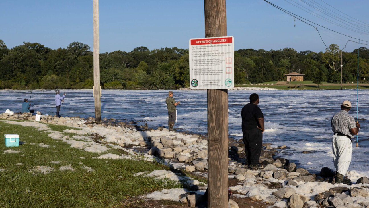 People fish in the flooded Pearl River on August 31, 2022 in Jackson, Mississippi.