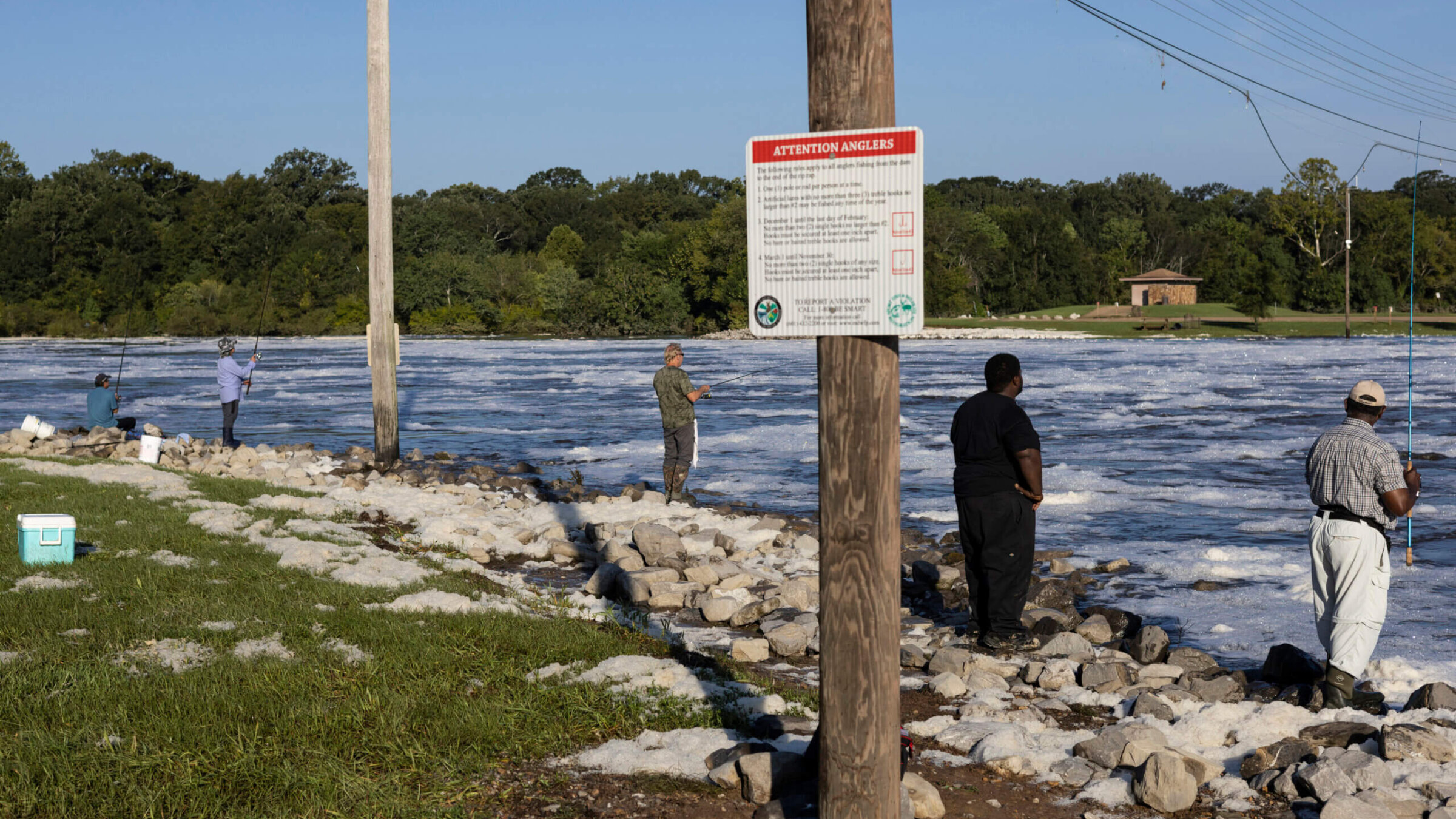 People fish in the flooded Pearl River on August 31, 2022 in Jackson, Mississippi.