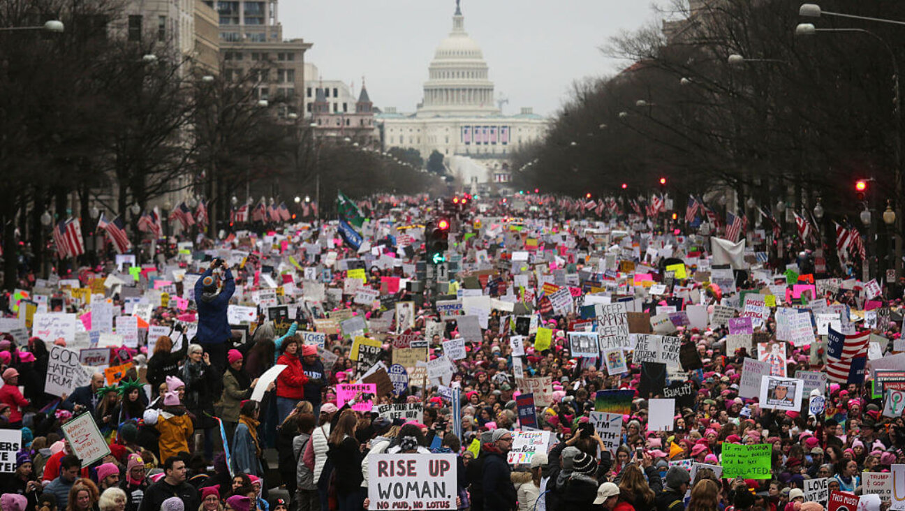 Protesters walk during the Women's March on Washington, with the U.S. Capitol in the background, on January 21, 2017 in Washington, DC. 