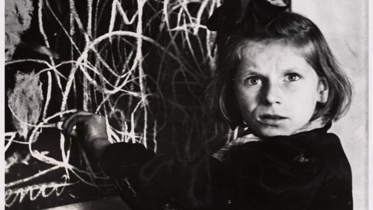 Tereska standing by her drawing of “home” in a home for emotionally disturbed children, in Warsaw, Poland, 1948.