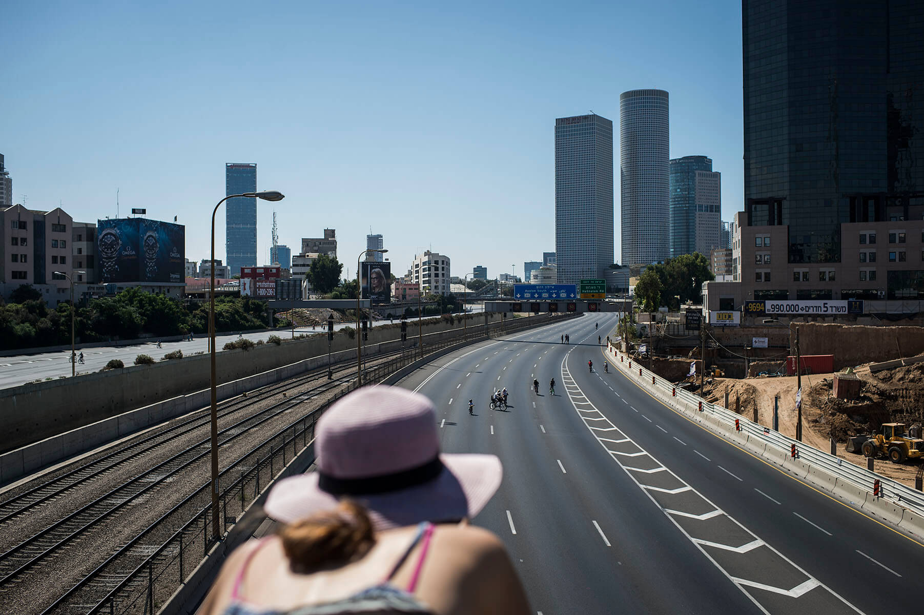 People ride bicycles in the middle of carless roadways in Tel Aviv on Yom Kippur 2014.