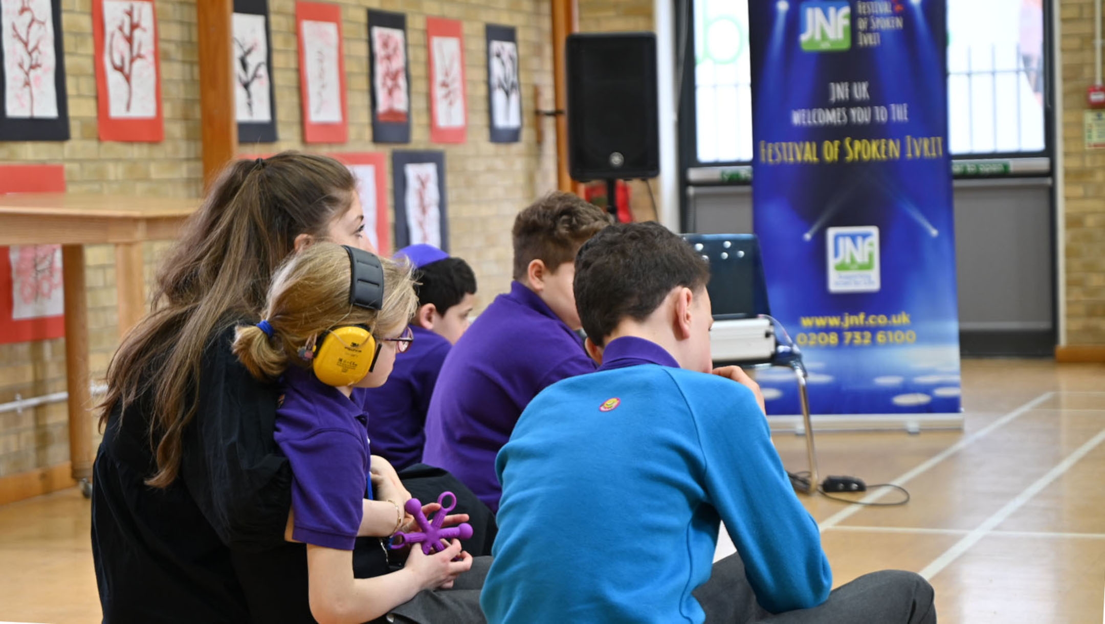 Students at the Gesher School in London watch a theater show, March 7, 2022. (Cnaan Liphshiz)