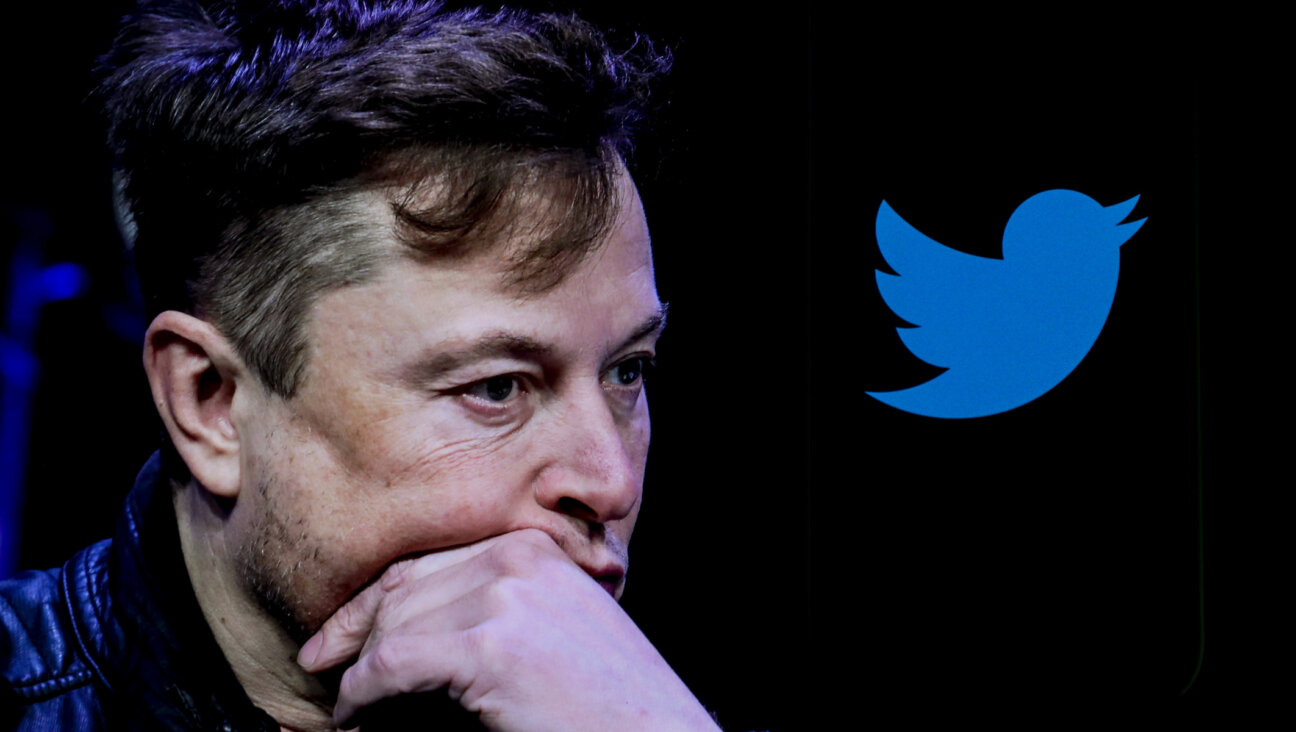 In this photo illustration, the image of Elon Musk is displayed on a computer screen and the logo of twitter on a mobile phone in Ankara, Turkiye on Oct. 6, 2022. (Muhammed Selim Korkutata / Anadolu Agency)