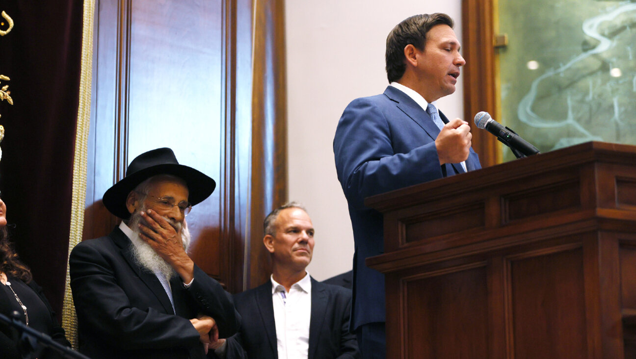 Rabbi Sholom Lipskar listens as Florida Gov. Ron DeSantis speaks during a press conference at the Shul of Bal Harbour on June 14, 2021 in Surfside, Florida. 