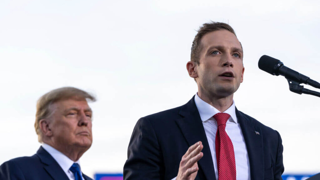 (L-R) Former U.S. President Donald Trump listens as Max Miller, Republican candidate for Ohio's 7th congressional district, speaks during a rally hosted by the former president at the Delaware County Fairgrounds on April 23, 2022 in Delaware, Ohio. 