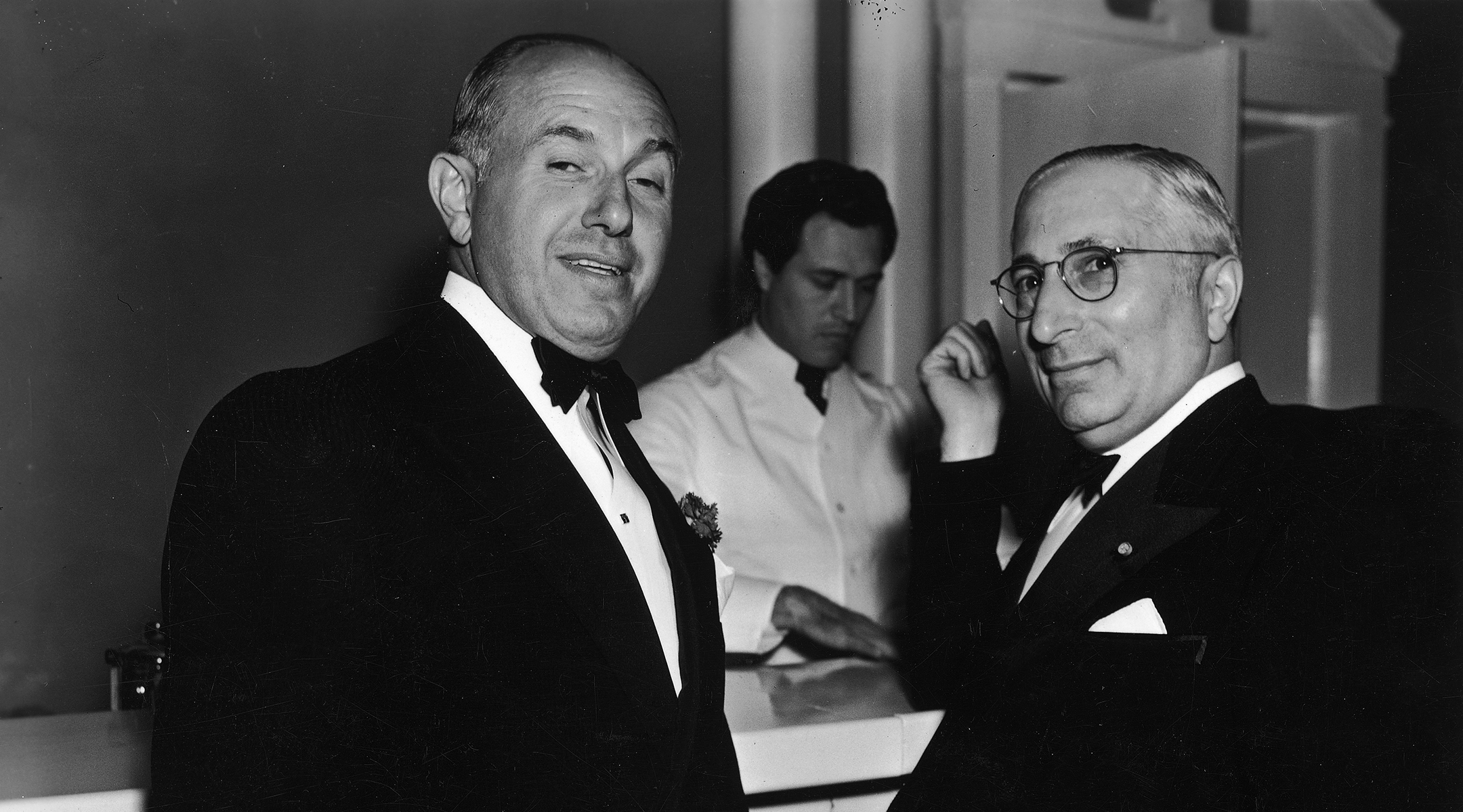 American film executives Jack Warner, left, and Louis Mayer right, together at a bar, 1940. (Hulton Archive/Getty Images)