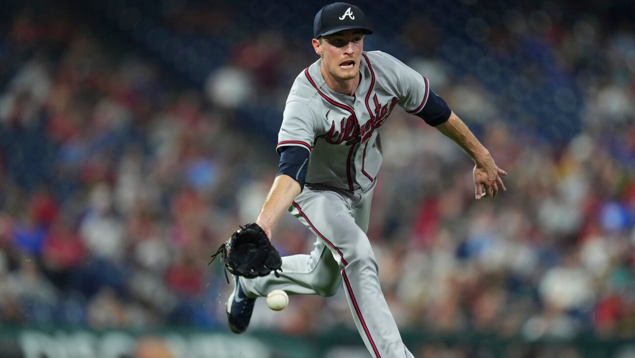 Max Fried flips the ball to first base during a game against the Philadelphia Phillies, July 25, 2022. (Mitchell Leff/Getty Images)