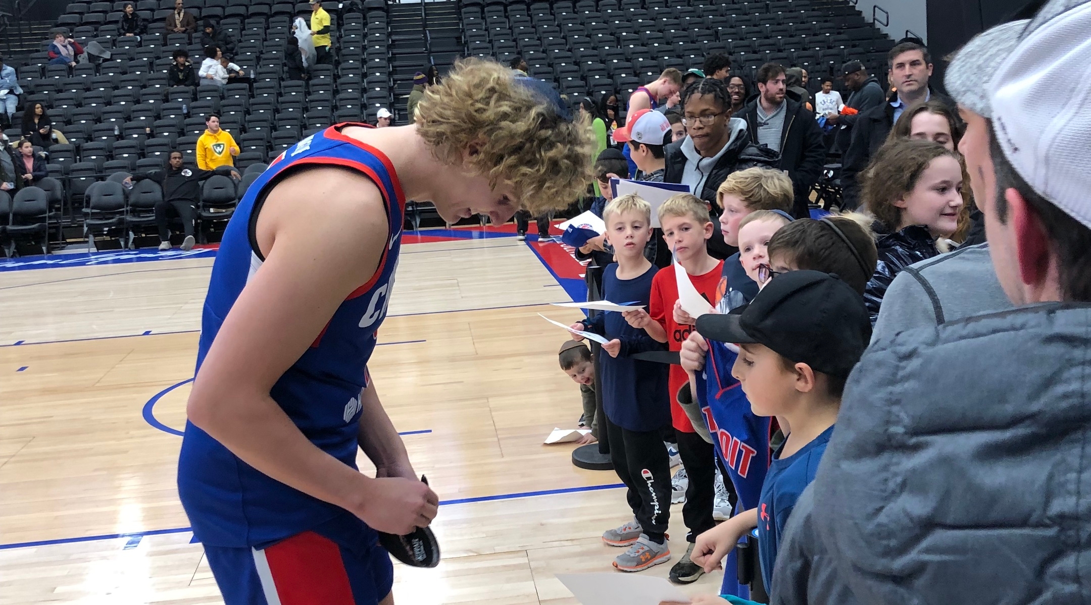 NBA G League player Ryan Turell signs a fan’s yarmulke following his game with Detroit’s Motor City Cruise, Nov. 17, 2022. The Yeshiva University graduate is the first Orthodox Jew to play for an NBA franchise team at any level. (Andrew Lapin/JTA)