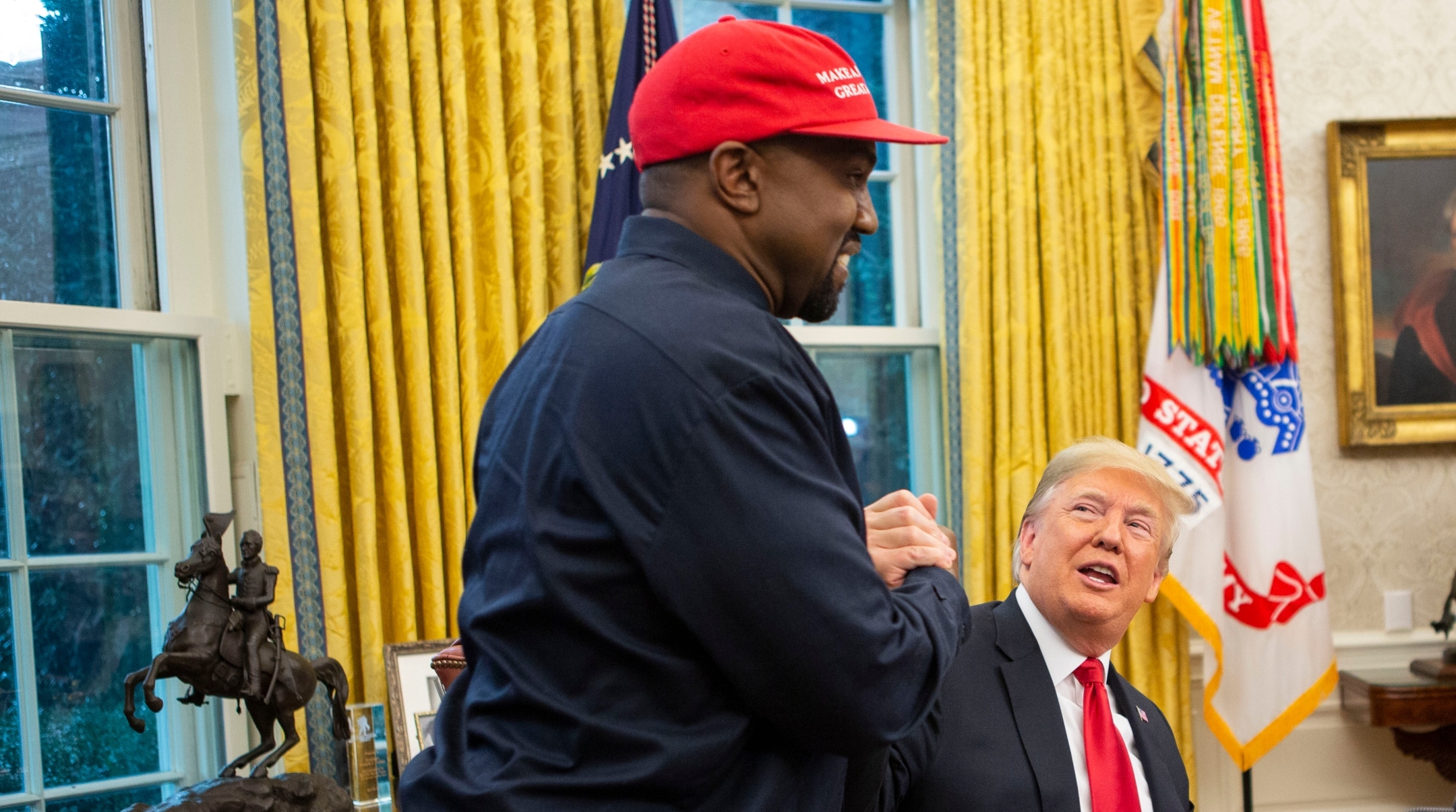 President Donald Trump and rapper Kanye West embrace in the Oval Office of the White House, Oct. 11, 2018. (Calla Kessler/The Washington Post via Getty Images)