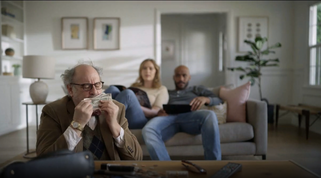 An ad for student debt refinancing company SoFi depicts a man stealing money from a young couple. The company said he was meant to represent a stereotypical professor; one critic said it looked like an antisemitic stereotype. (Screenshot)