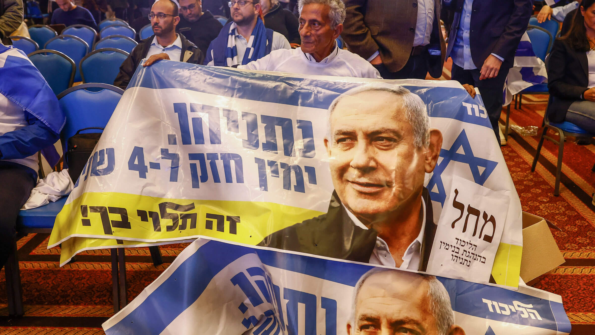 A supporter at the Likud party headquarters in Jerusalem, Israel, on Tuesday, Nov. 1, 2022. The sign he is holding reads, in Hebrew, "Netanyahu. A strong right for 4 years. It's up to you!"