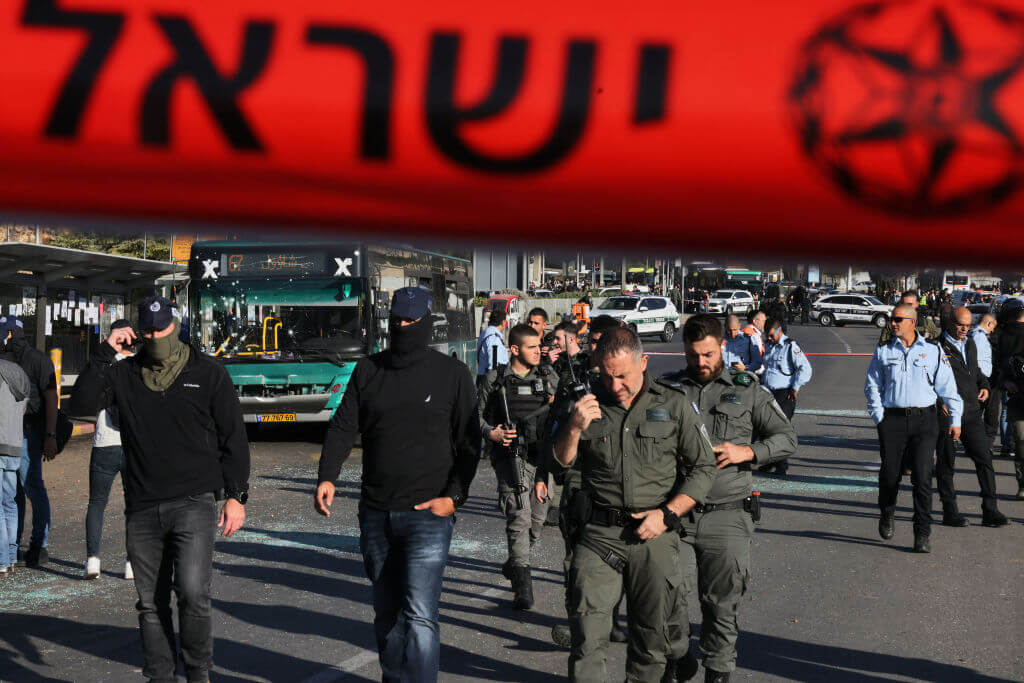 Israeli security forces gather at the scene of an explosion at a bus stop in Jerusalem on November 23, 2022. 