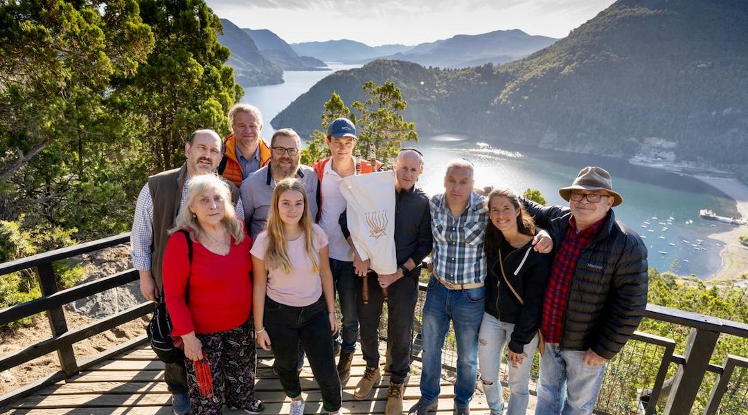 Claudio Ploit seen holding a Torah scroll with members of the San Martin de los Andes Jewish community. (Gustavo Castaign/ Courtesy Comunidad Hebrea San Martin de los Andes)