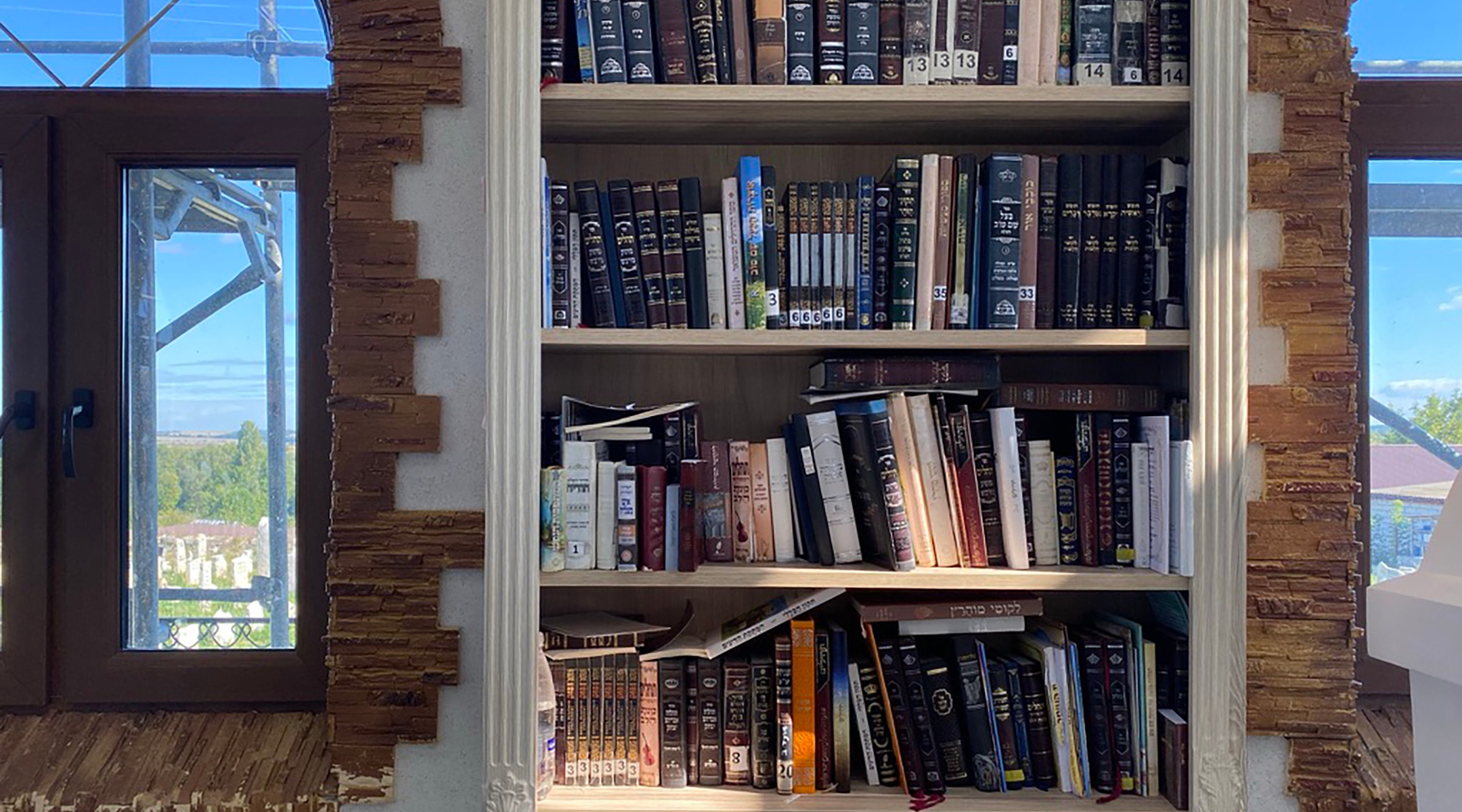 A bookshelf at Medzhybizh with texts in both Hebrew and Russian. (Jacob Judah)