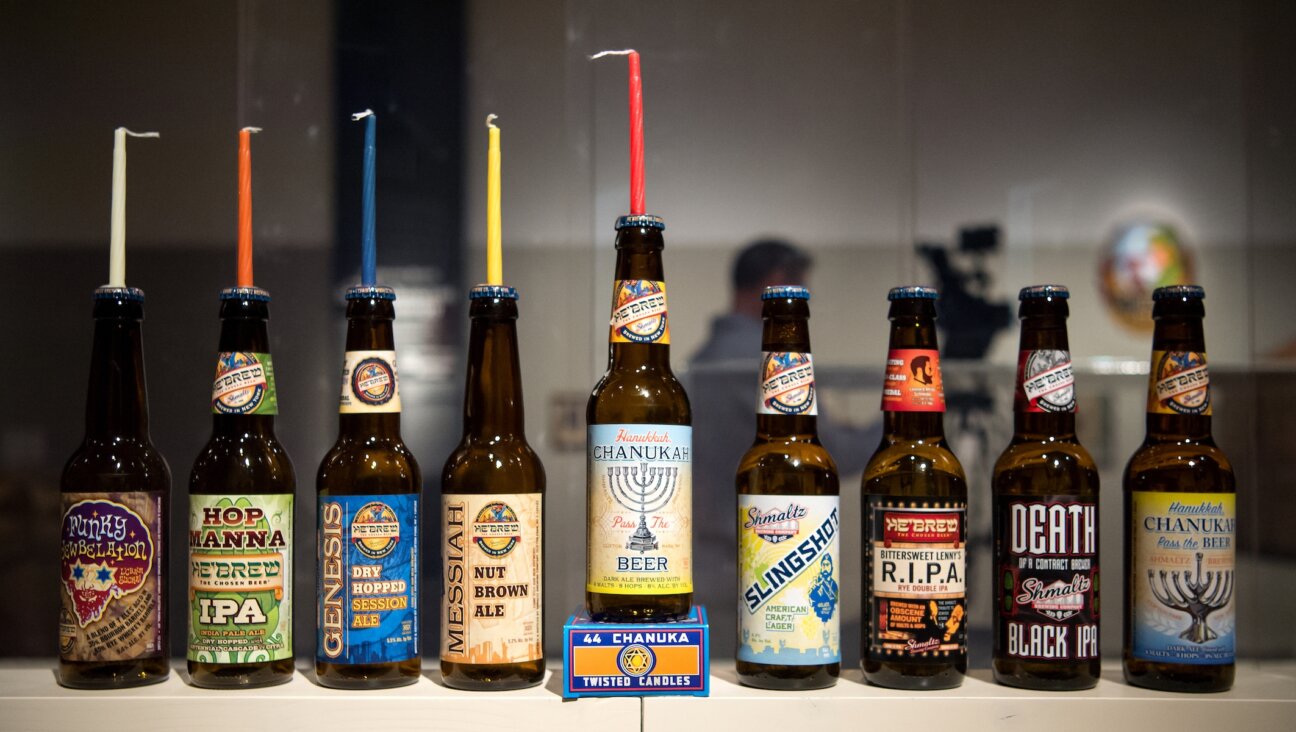 Various beer bottles by Shmaltz Brewery on display in an exhibition on “Jewish brewing stories” at the Jewish Museum in Munich, Germany, April 11, 2016. (Sven Hoppe/picture alliance via Getty Images)