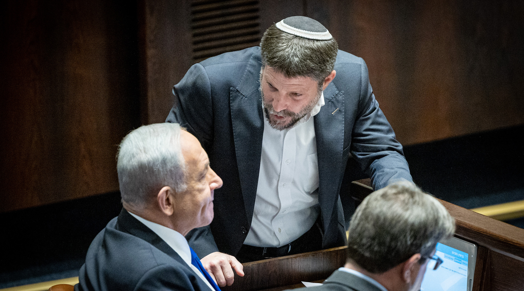 Benjamin Netanyahu, left, speaks with Religious Zionist party head Bezalel Smotrich during a vote in the plenum session at the assembly hall of the Knesset, the Israeli parliament in Jerusalem, Dec. 20, 2022. (Yonatan Sindel/Flash90)