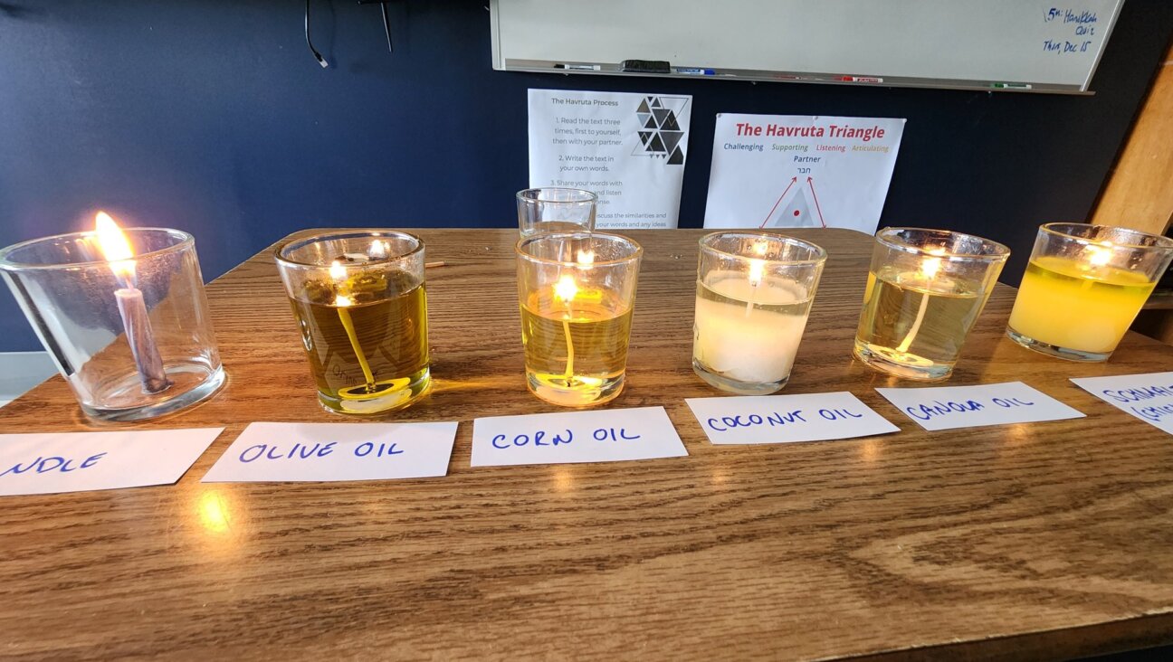 Candles made from wax, olive oil, canola oil, corn oil, coconut oil and chicken fat burn in a Georgia Jewish day school classroom. 