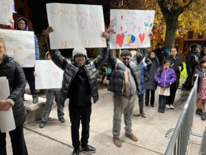 Young boys hold signs against hate and in support of love.